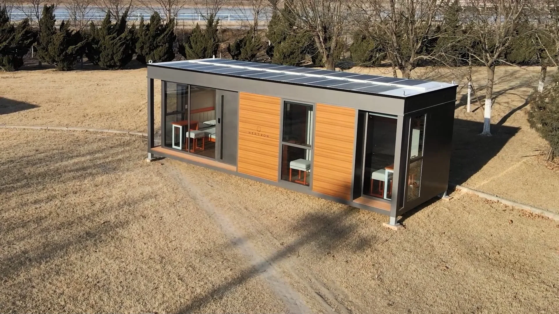 Exterior view of the Nestron Legend Two with wood siding, dark trim, and large windows