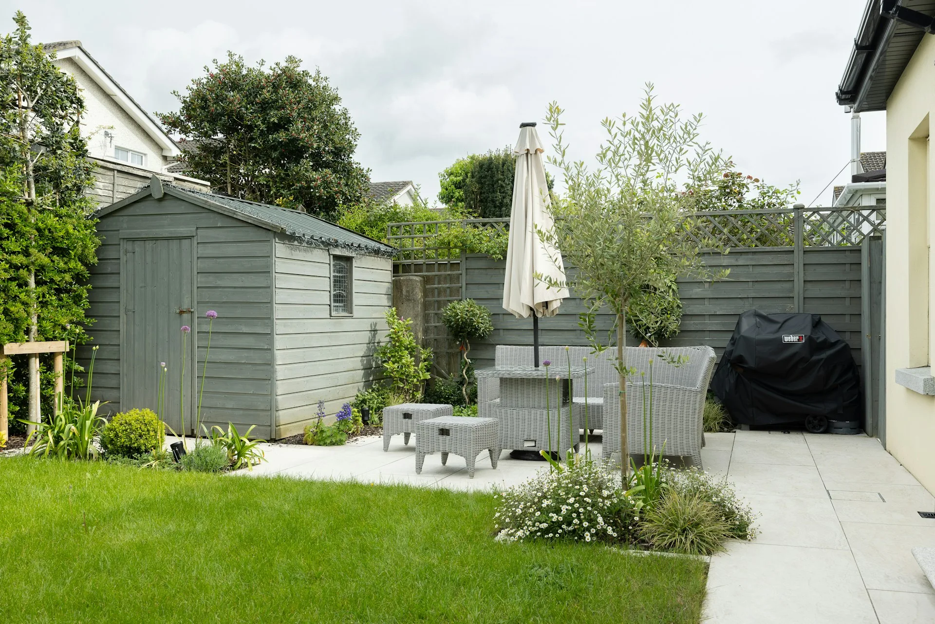 Prefab ADU in a landscaped backyard with outdoor seating and greenery