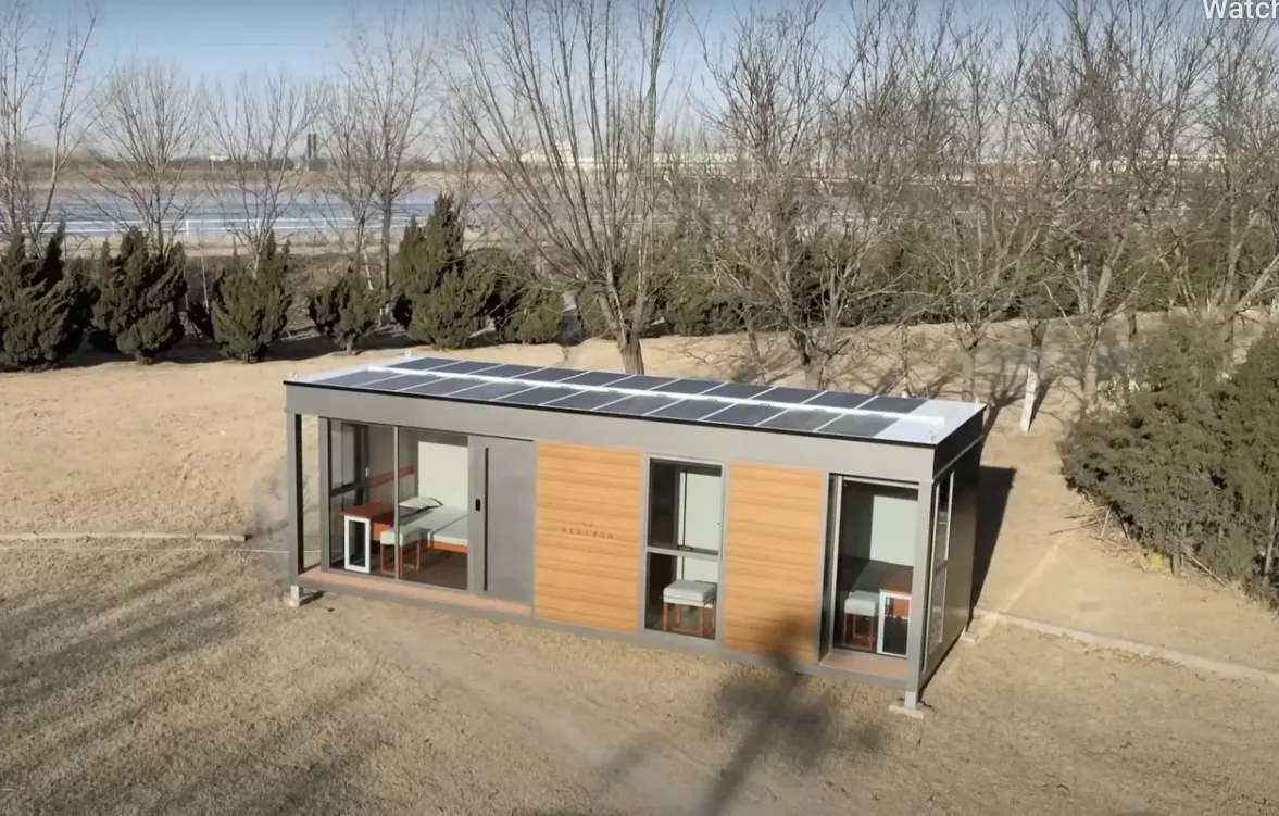 Exterior view of a wood-sided modular home in an open outdoor setting