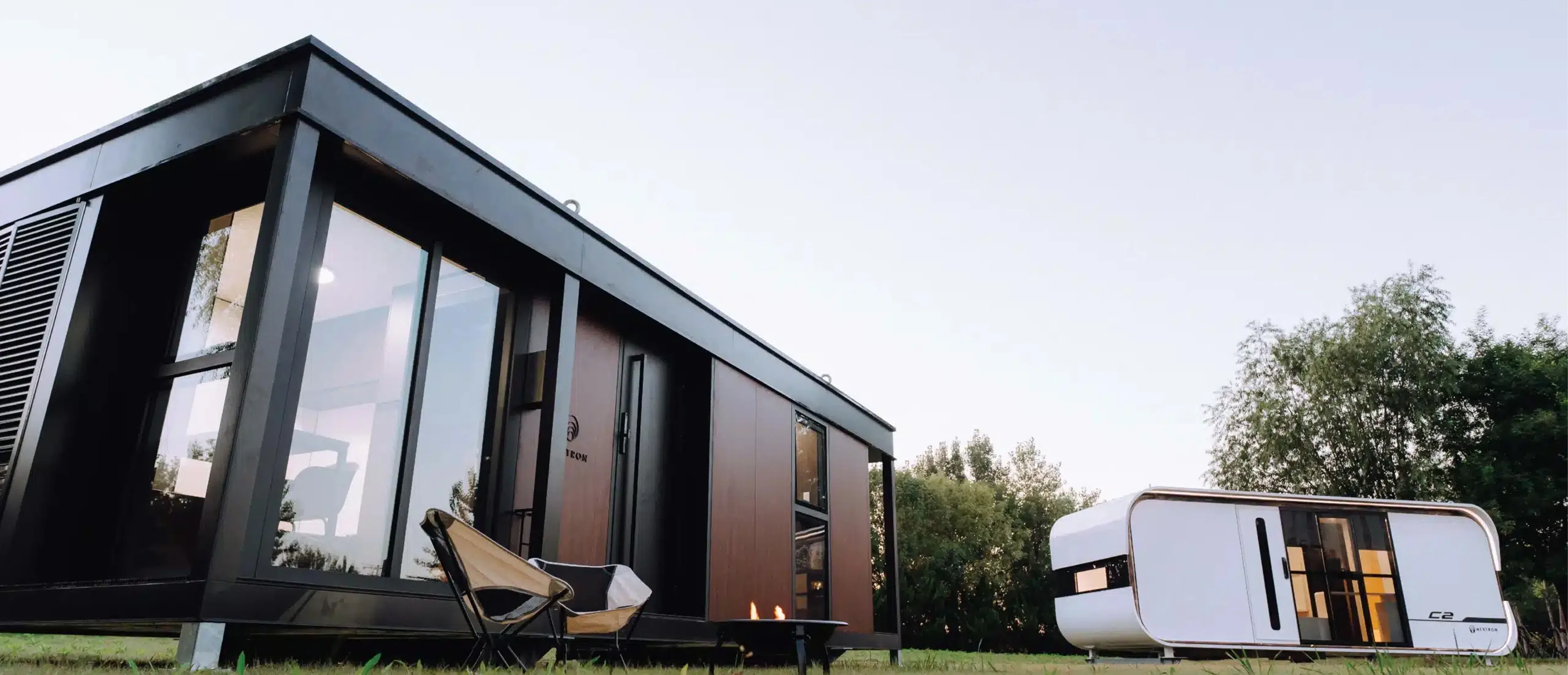 Exterior side view of a modern modular home with wood siding and dark framing