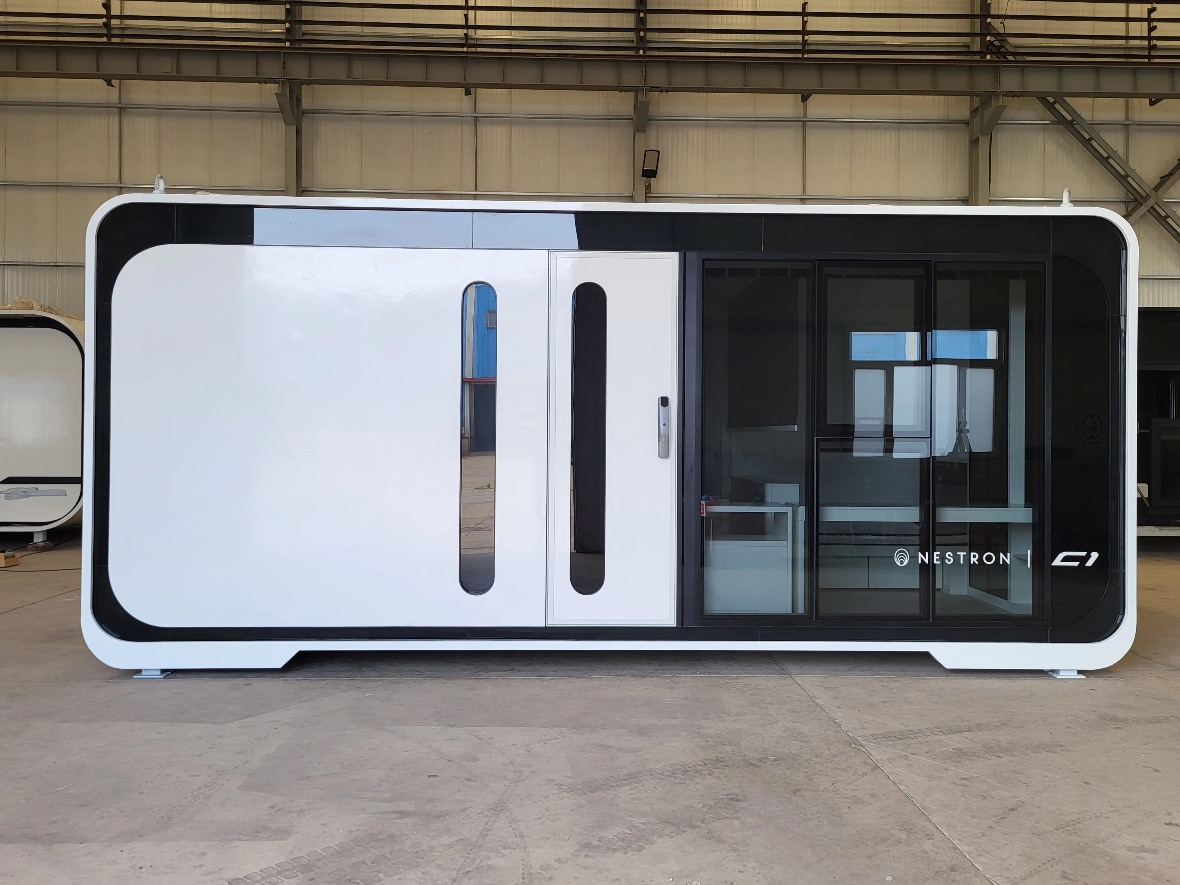 Nestron C1 modular unit exterior with sliding glass door, sustainability feature