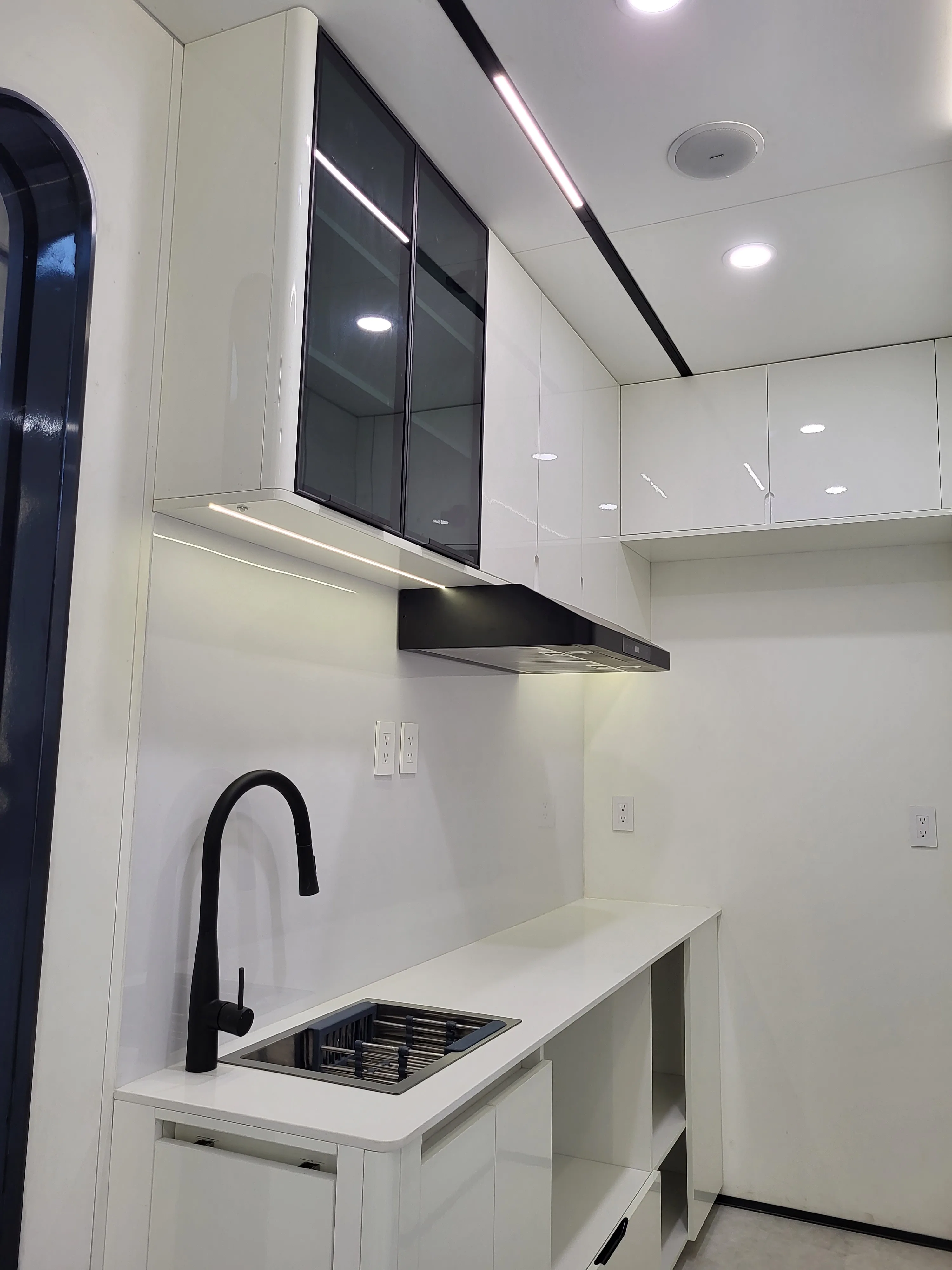 Nestron Cube One kitchen rendering with a sink, black faucet, range hood, and white countertop
