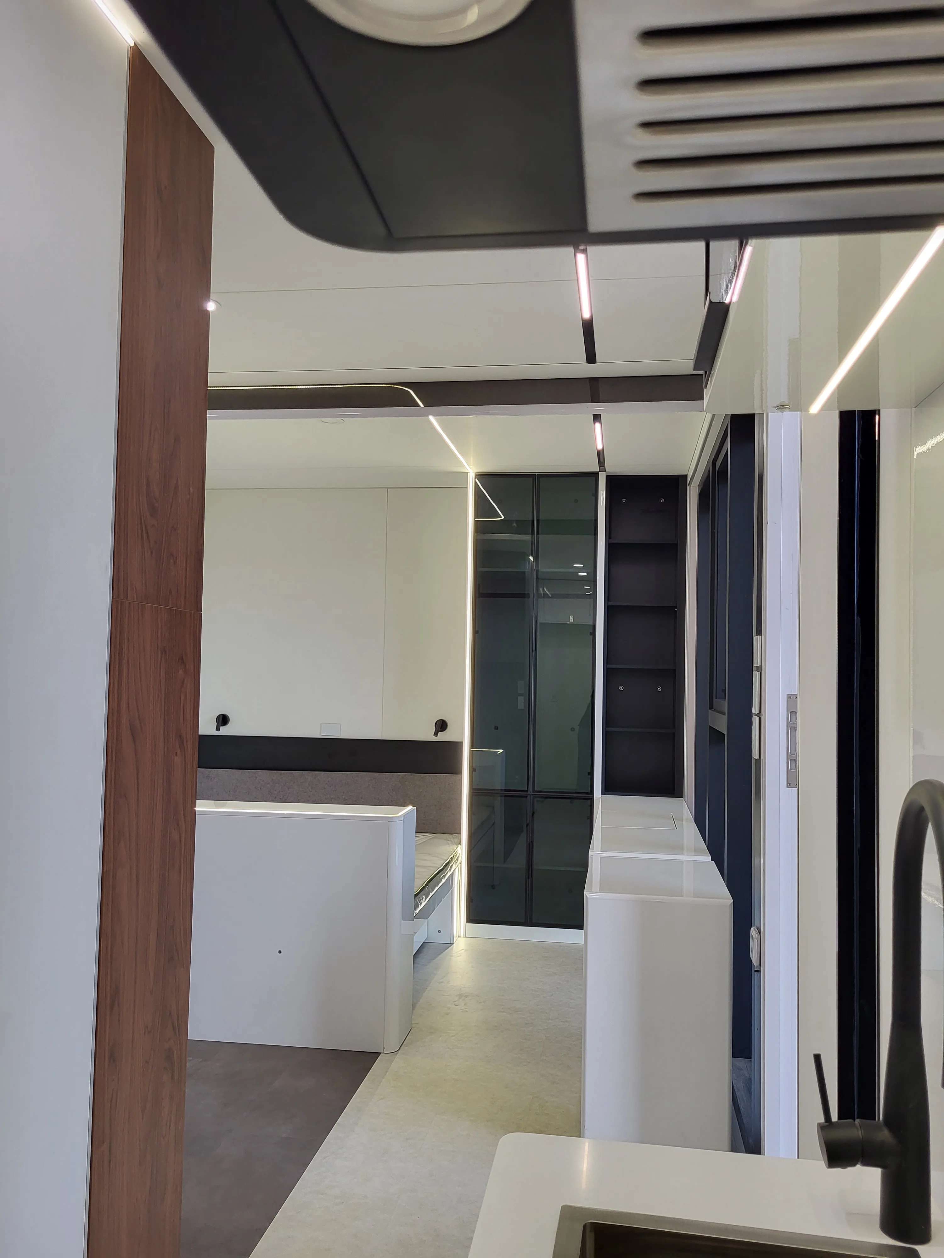 Nestron Cube One kitchen rendering with built-in cabinetry, white countertops, and dark upper cabinets