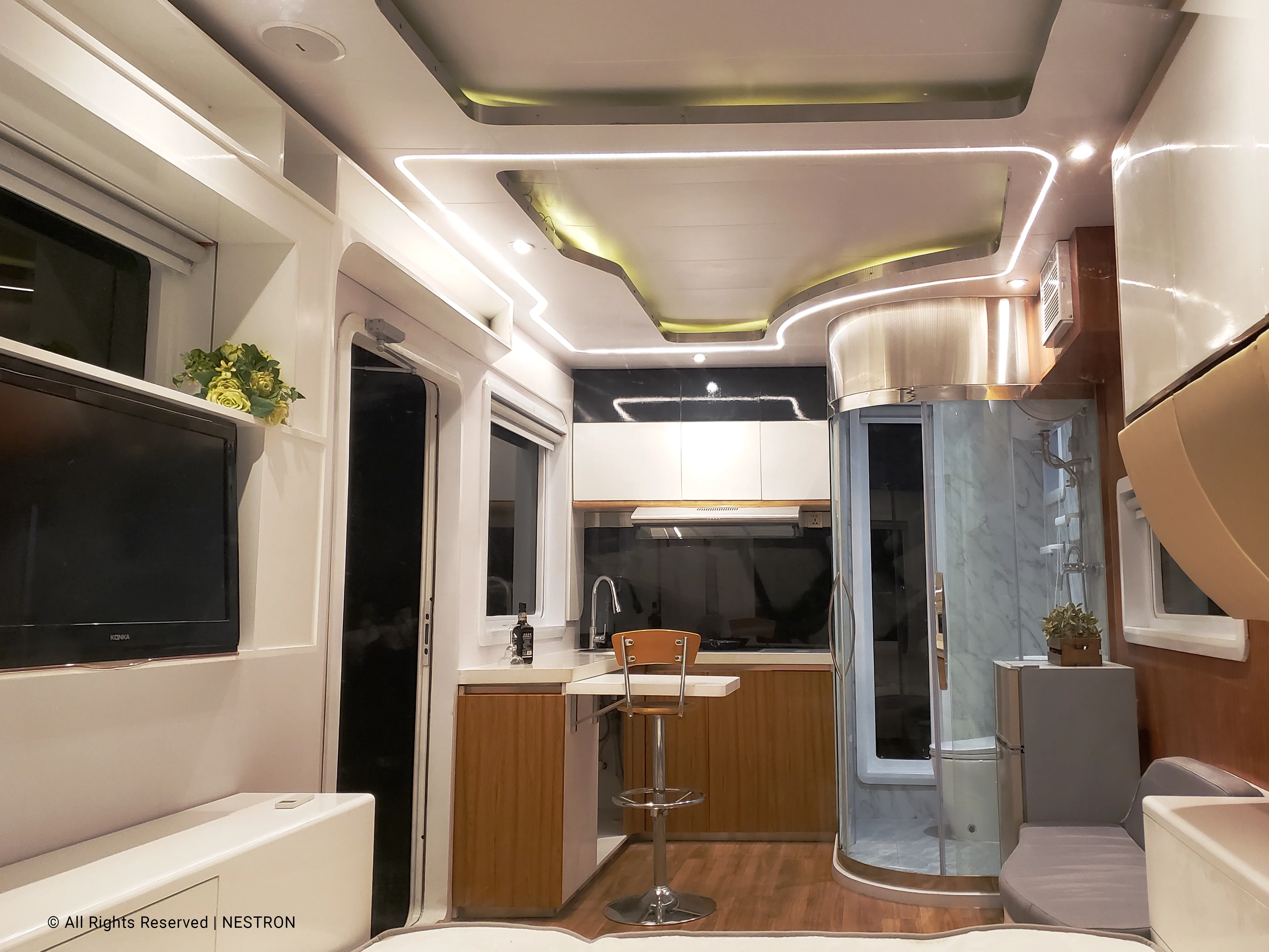 Nestron Cube One interior rendering with a compact kitchen, dark cabinetry, and warm wood accents