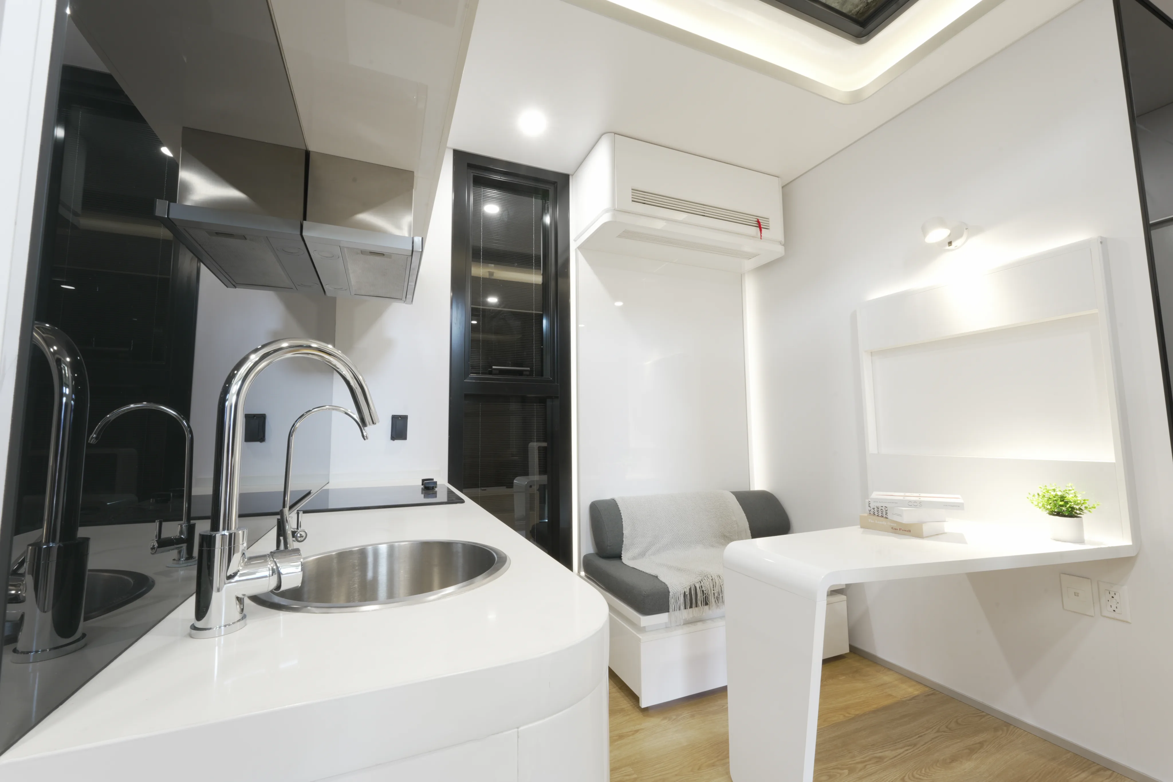Nestron modular home kitchen interior with sink, cabinetry, and lounge seating