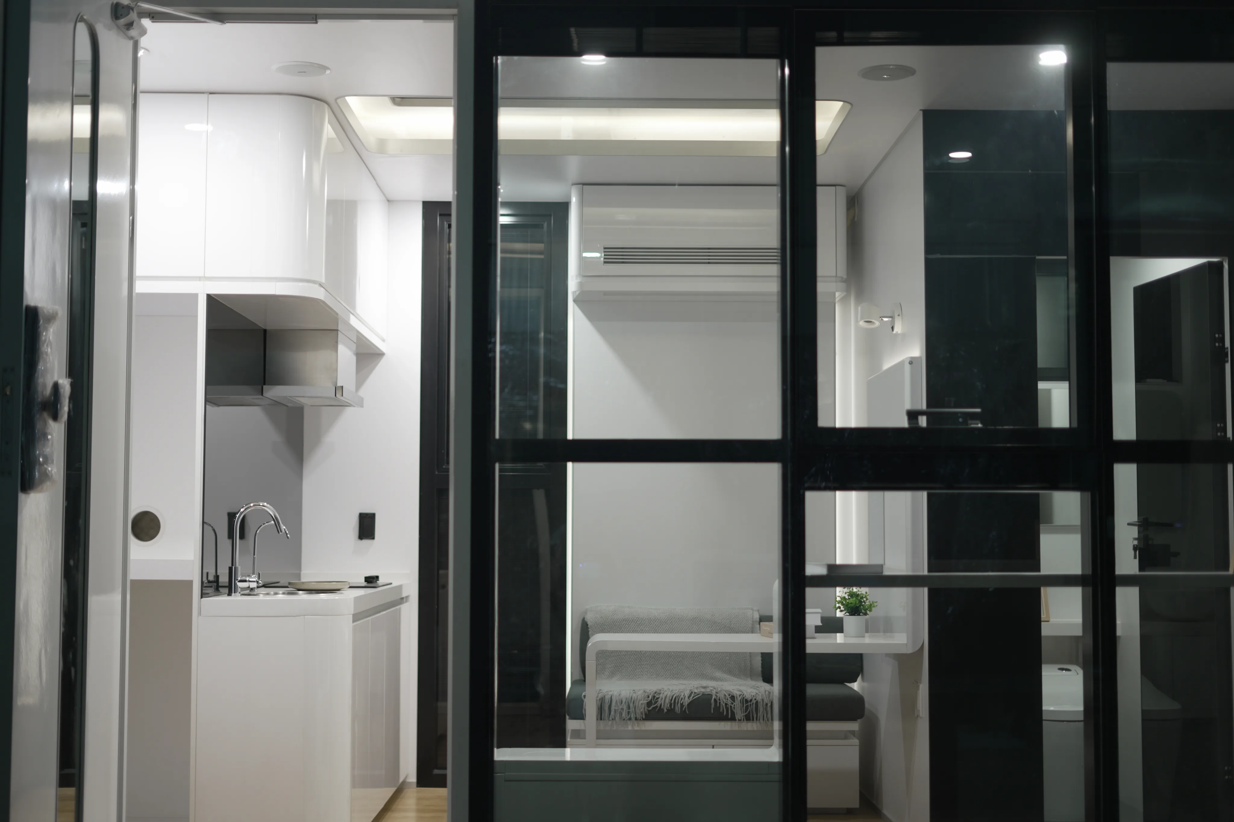 Nestron modular home kitchen interior with glass partition and bedroom view