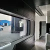 Nestron Cube Two X interior with dark paneling and window view