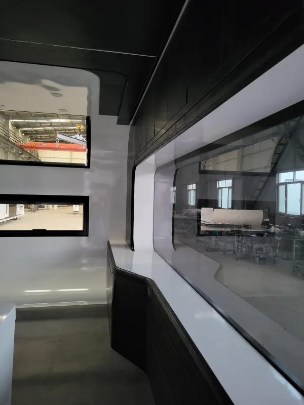 Nestron Cube Two X interior with a large glass window wall, built-in counter, and small side windows