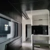 Nestron Cube Two X kitchen island with overhead cabinets, dark splashback, and a large side window