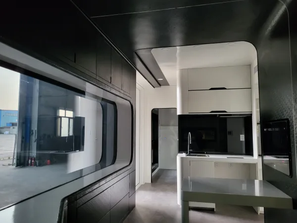 Nestron Cube Two X kitchen island with overhead cabinets, dark splashback, and a large side window