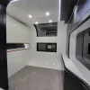 Nestron Cube Two X interior showing a curved white ceiling, two windows, and built-in screen niches