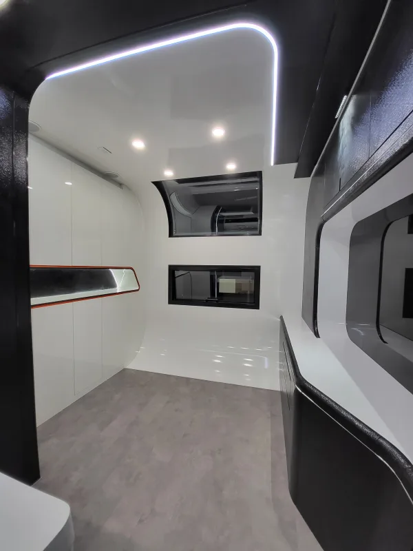 Nestron Cube Two X interior showing a curved white ceiling, two windows, and built-in screen niches