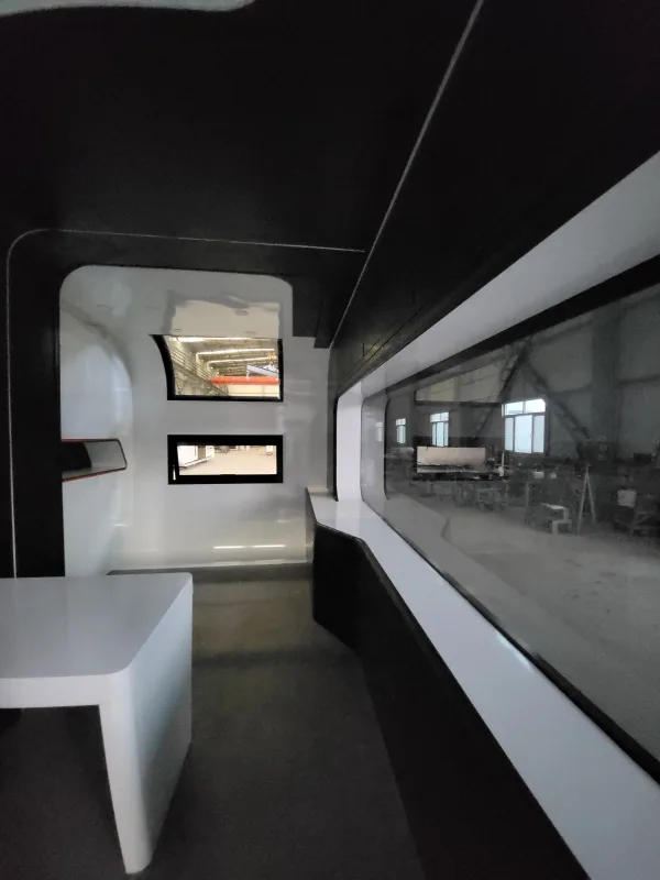 Nestron Cube Two X interior rendering showing a panoramic window, white table, and compact living space