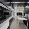 Nestron Cube Two X interior rendering with a long panoramic window, white table, and dark cabinetry