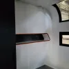 Nestron Cube Two X interior rendering showing a built-in wall shelf with dark trim and small windows