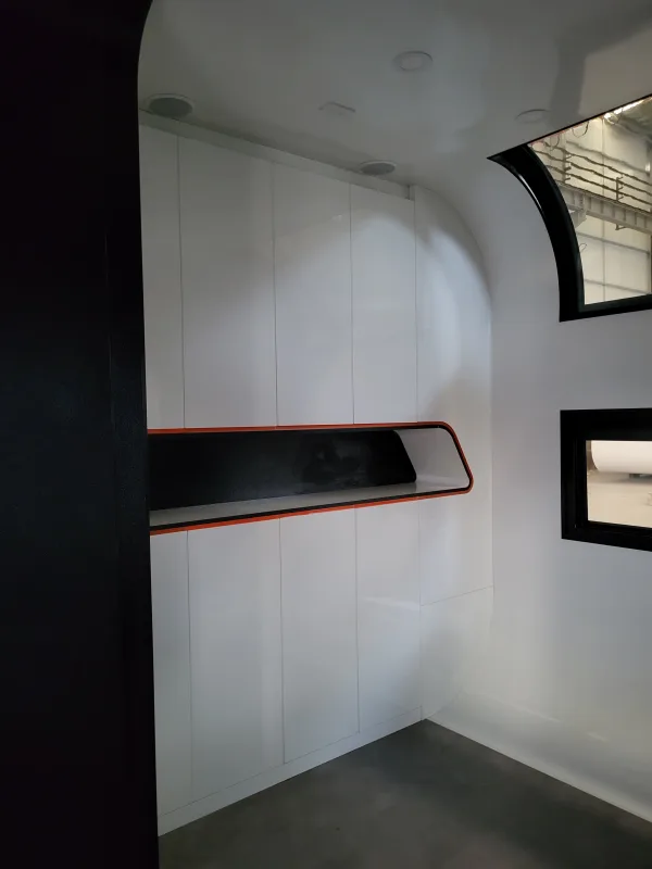Nestron Cube Two X interior rendering showing a built-in wall shelf with dark trim and small windows