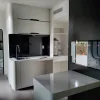 Nestron Cube Two X kitchen rendering with dark cabinetry, a white countertop, and built-in appliances