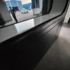 Close-up interior rendering of the Nestron Cube Two X panoramic window and dark countertop