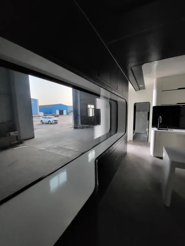 Nestron Cube Two X interior rendering showing a panoramic side window, built-in seating, and dark finishes