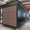 Rear exterior view of the Nestron Legend One unit showing taupe paneling and dark cladding in the factory
