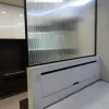 Nestron Legend One interior with a fluted glass partition and white built-in storage console