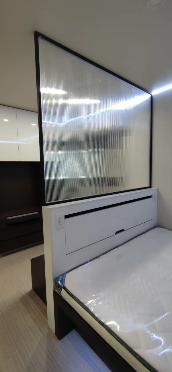 Nestron Legend One interior with a fluted glass partition and white built-in storage console