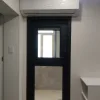 Nestron Legend One entry door with a glass panel and wall-mounted split air conditioning unit above