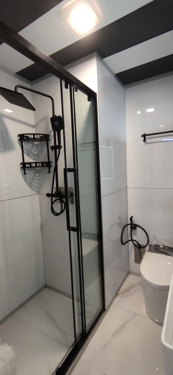 Nestron Legend One bathroom rendering with a glass shower enclosure, black shower fixtures, and a white toilet