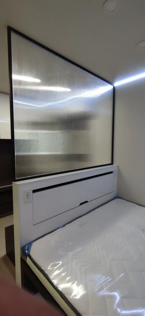 Nestron Legend One interior rendering with a large mirrored wall panel, white built-in drawers, and dark trim