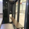 Nestron Legend One interior rendering showing a narrow hallway with floor-to-ceiling glass windows and dark wall panels