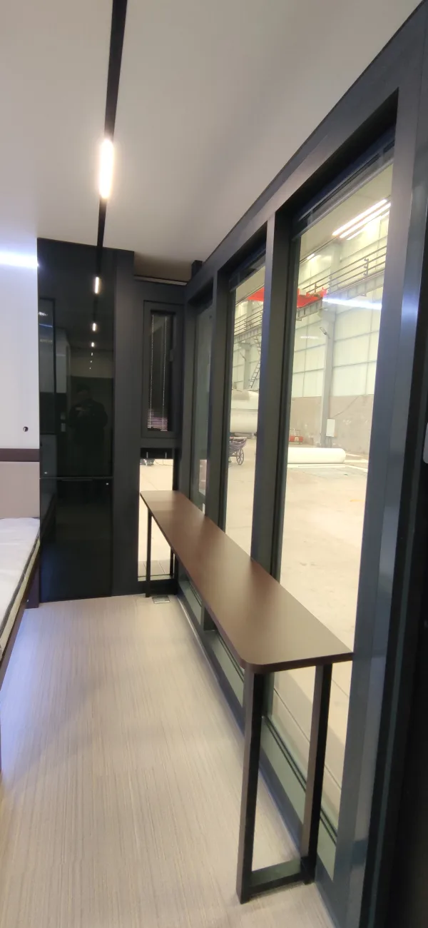 Nestron Legend One interior rendering showing a narrow hallway with floor-to-ceiling glass windows and dark wall panels