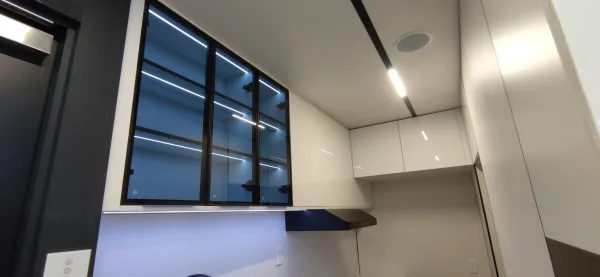 Nestron Legend One interior rendering with a large dark framed window, white walls, and a black countertop