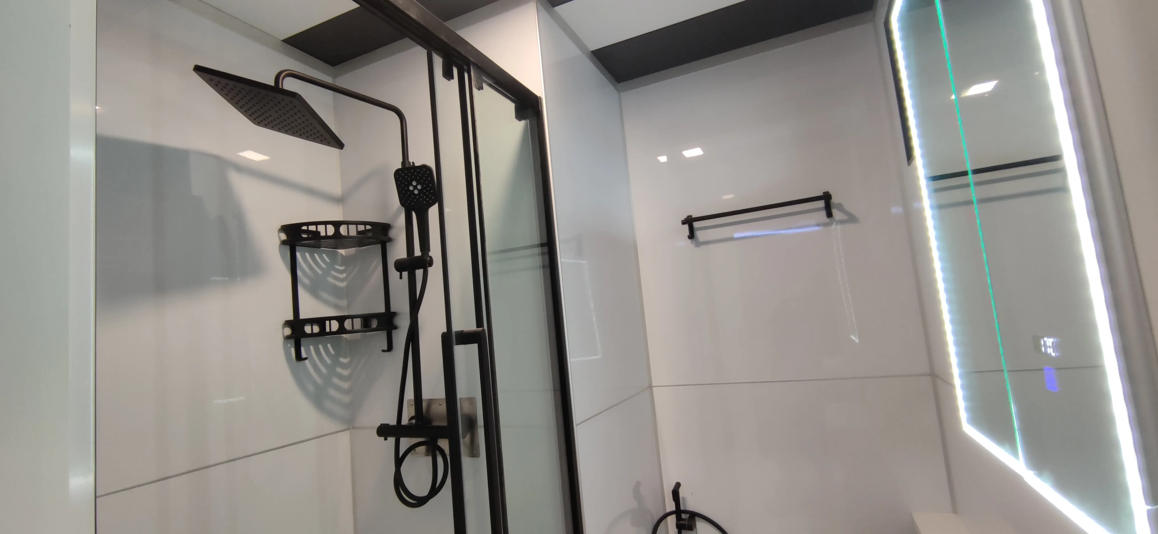 Nestron Legend One bathroom rendering with black shower fixtures, white tiled walls, and an entry door