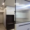 Nestron Legend One interior rendering showing a TV console, mirrored wall panels, and white cabinetry