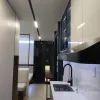 Nestron Legend One kitchen rendering with a white countertop, black faucet, dark cabinetry, and glossy wall panels