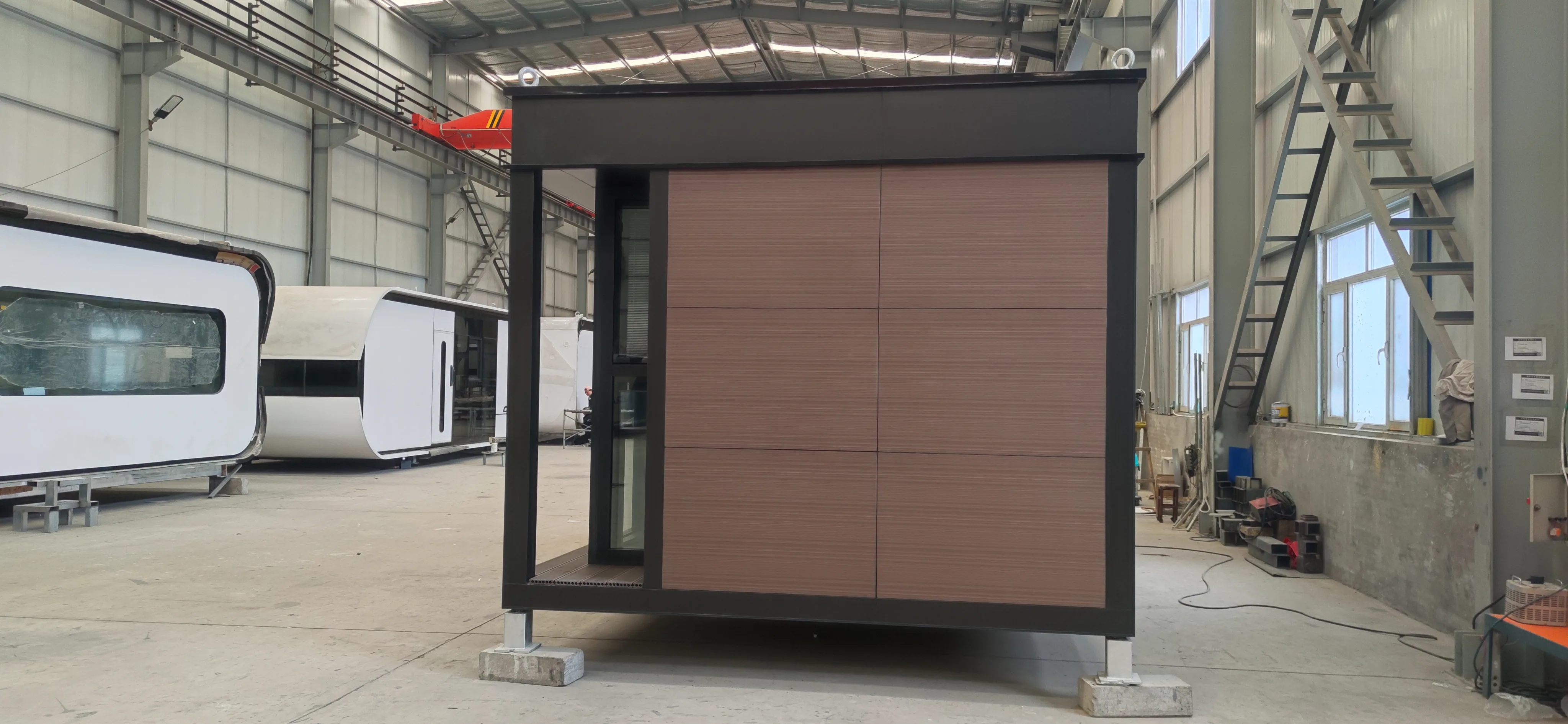 Rear exterior rendering of the Nestron Legend One with brown facade panels and dark structural trim