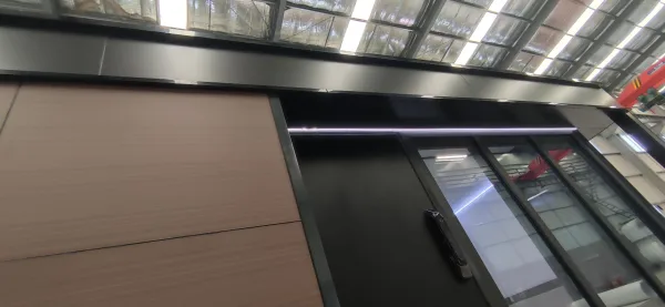 Nestron Legend One interior rendering showing dark cabinetry, a black countertop, and upper windows