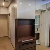 Nestron Legend One interior rendering showing a central entertainment console, dark wood cabinetry, and mirrored wall panels