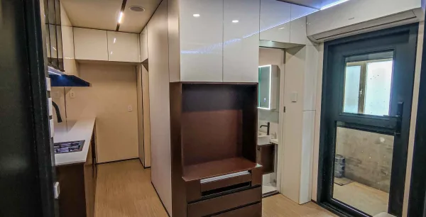 Nestron Legend One interior rendering showing a central entertainment console, dark wood cabinetry, and mirrored wall panels