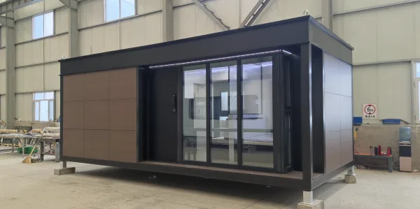 Front exterior rendering of the Nestron Legend One with large glass doors, dark trim, and wood facade panels