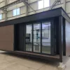 Exterior rendering of the Nestron Legend One with large glass doors, dark trim, and wood facade panels