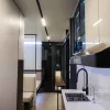 Nestron Legend One kitchen rendering with a sink, dark cabinetry, glossy wall panels, and range hood