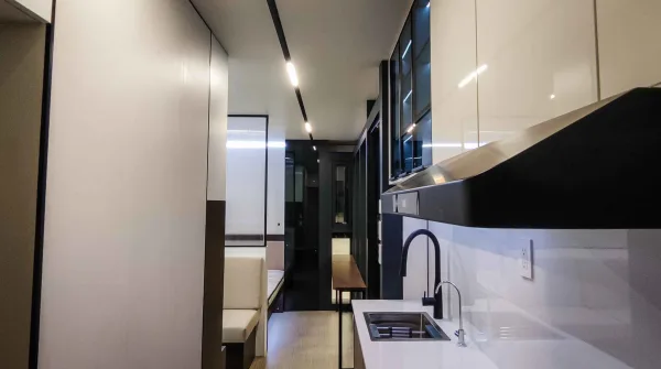 Nestron Legend One kitchen rendering with a sink, dark cabinetry, glossy wall panels, and range hood