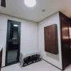 Nestron Legend Two interior rendering showing a compact room with white walls, dark wood panels, and recessed lighting