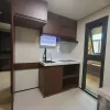 Nestron Legend Two kitchen rendering with dark wood cabinetry, white countertops, a sink, and built-in appliances