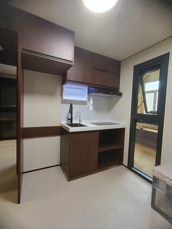 Nestron Legend Two kitchen rendering with dark wood cabinetry, white countertops, a sink, and built-in appliances