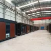 Nestron Legend Two exterior view inside a factory showing multiple modular units lined along the production floor