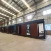 Nestron Legend Two exterior view inside a factory showing the modular unit with dark trim and wood facade panels