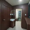 Nestron Legend Two interior rendering showing a hallway with dark wood cabinetry, mirrors, and recessed lighting