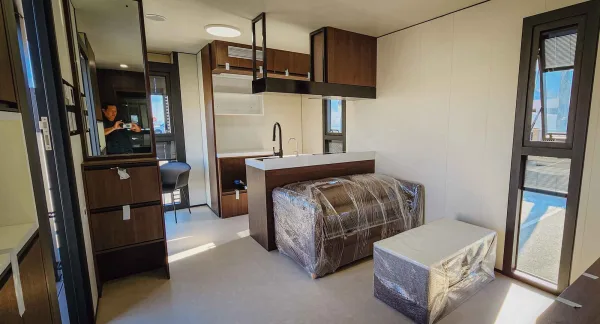 Nestron Legend Two kitchen rendering with wood cabinetry, white countertops, sink, and built-in appliances
